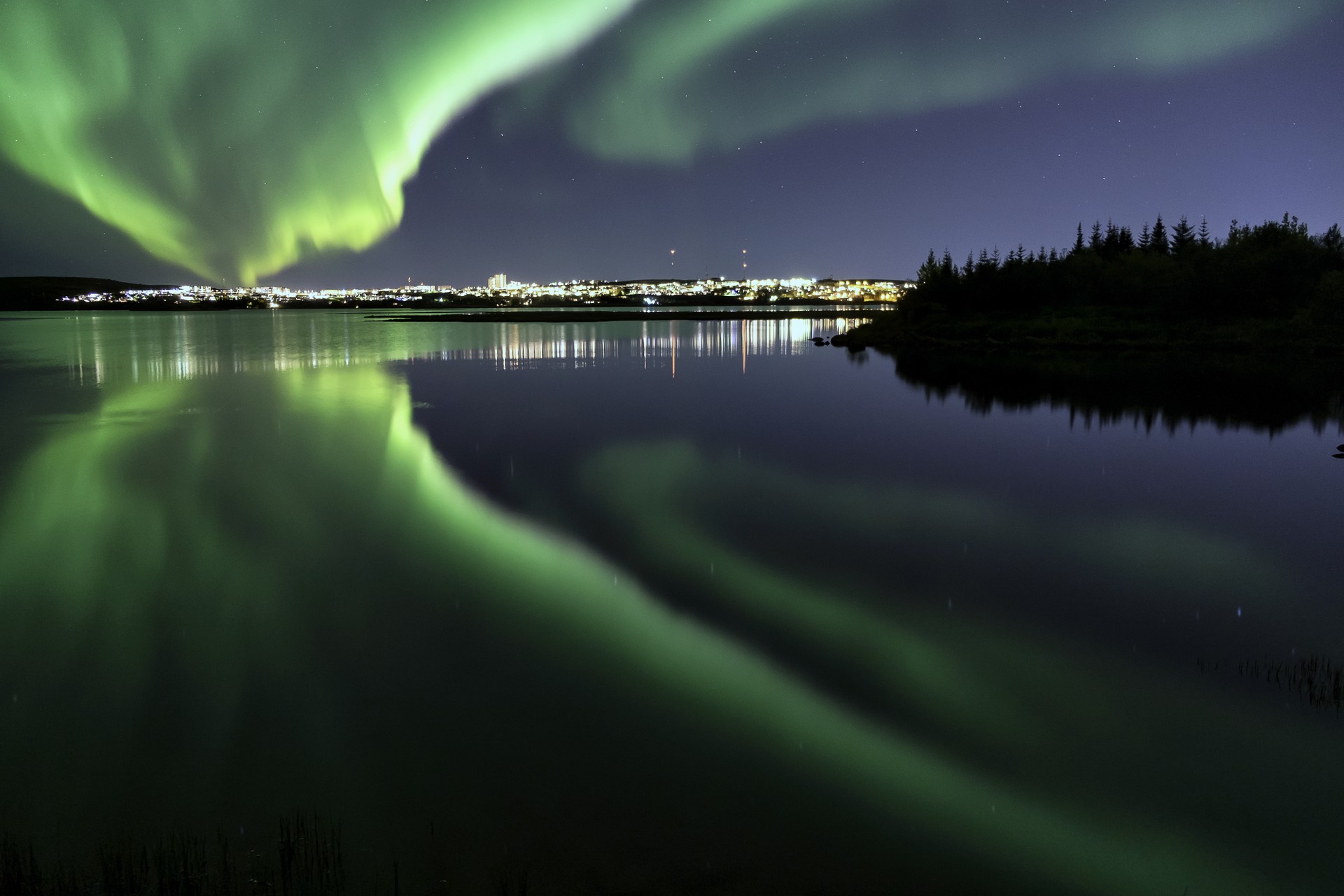 Northern lights above the water near Reykyavik in Iceland