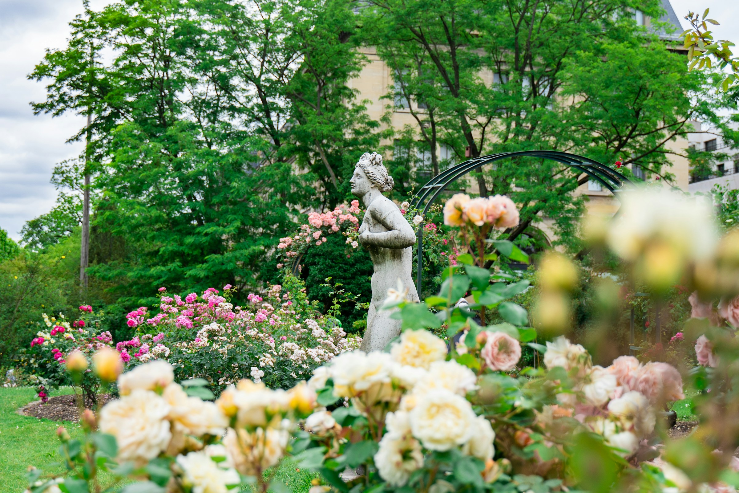 Garden filled with statues and flowers in Paris, France, one of the most romantic places in Europe