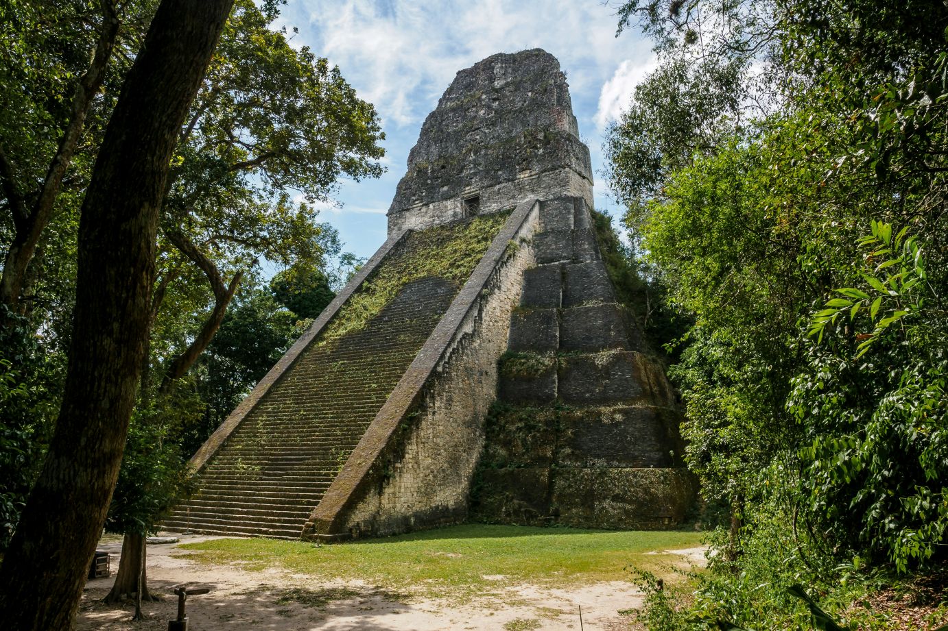 Tikal ruins glimpsed through the trees in Guatemala