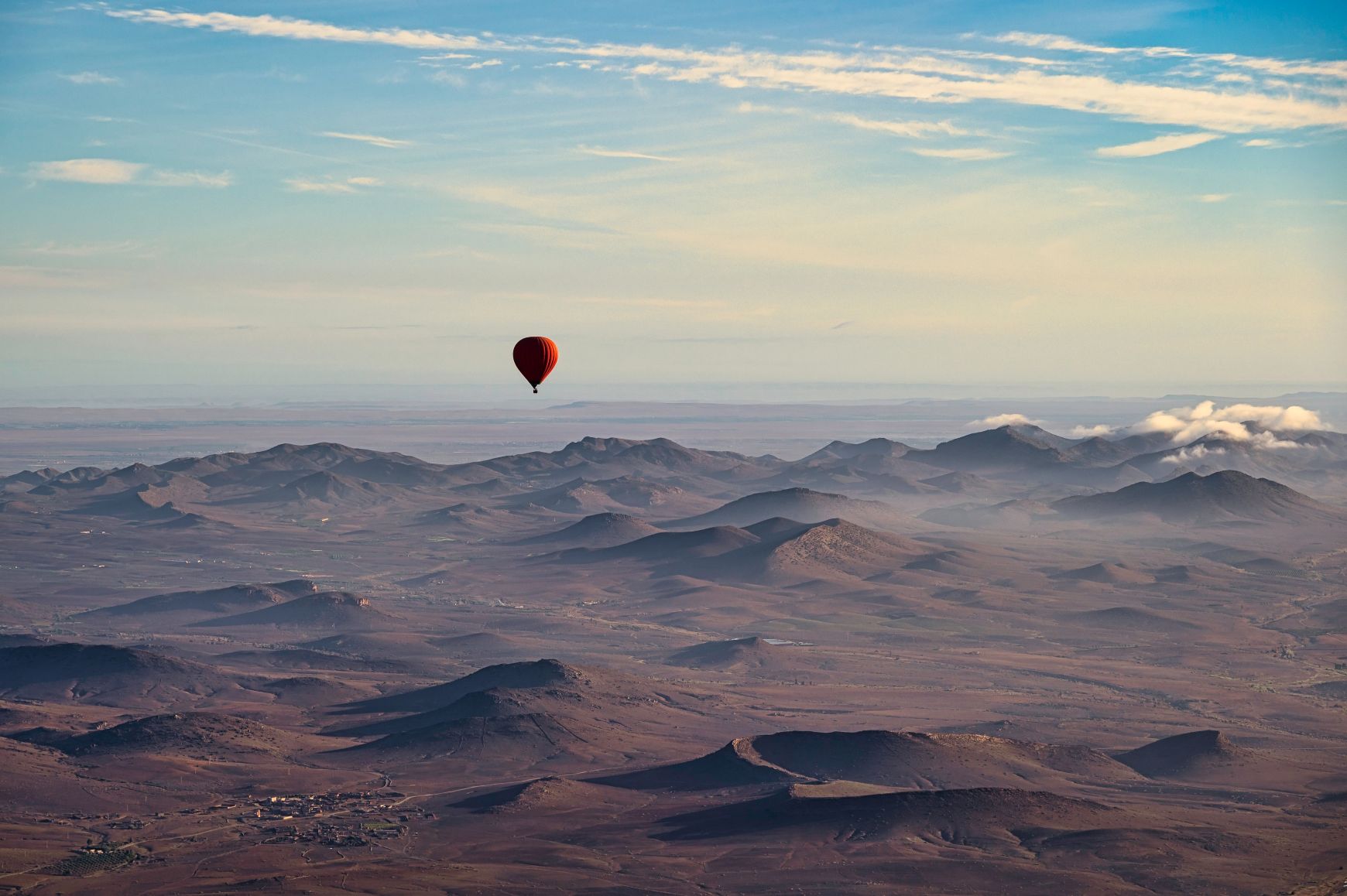 Hot air balloon over the Agafay desert near Marrakech on a clear spring day