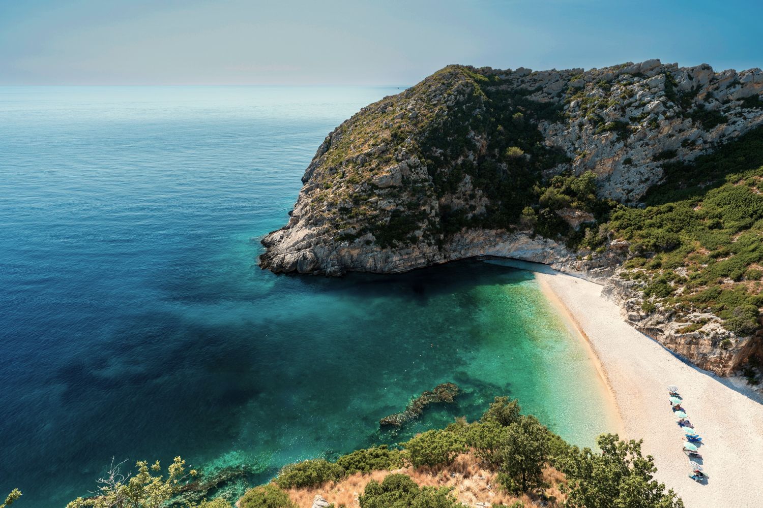 Unique things to do in Albania: exploring hidden coves and quiet beaches, such as the Bay of Grama