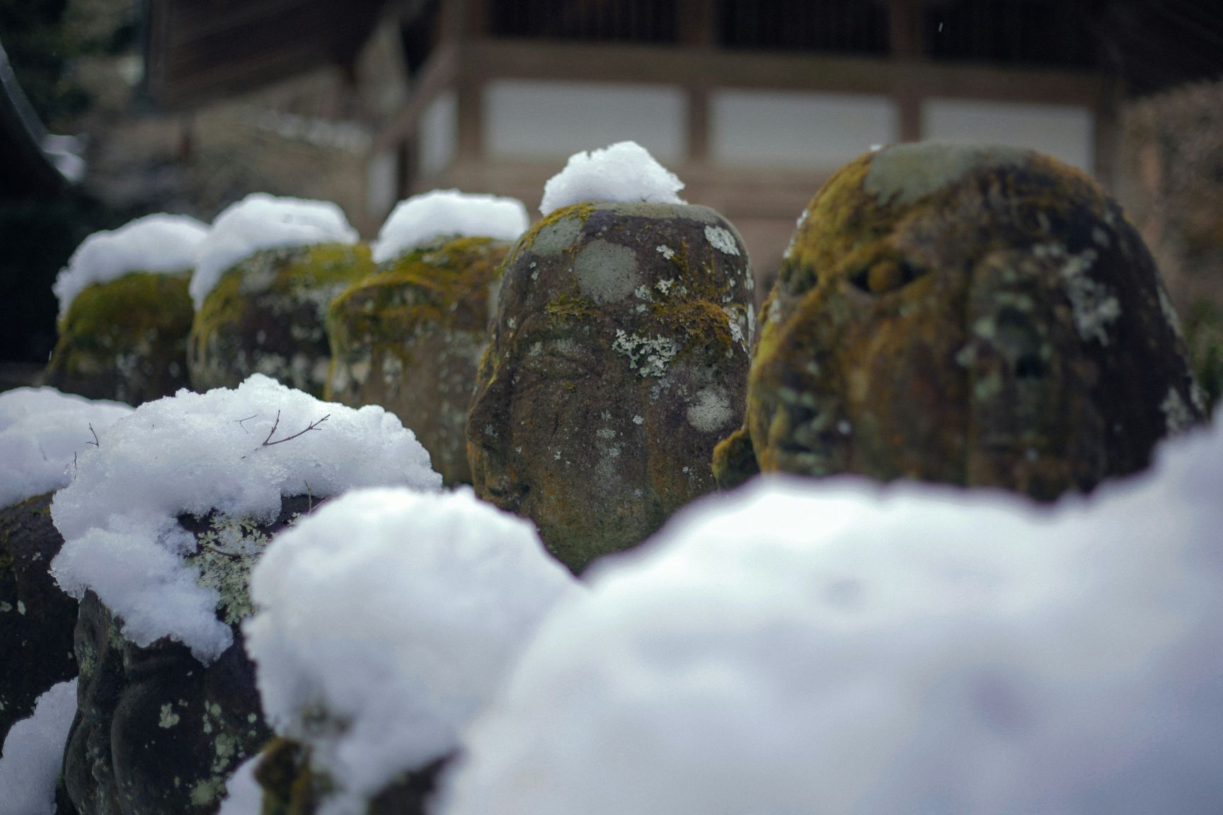 Statues covered in snow at Otagi Nenbutsu-ji Temple in Kyoto