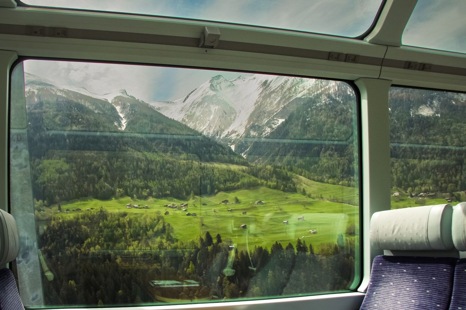 Views of green mountains from the Glacier Express in Switzerland