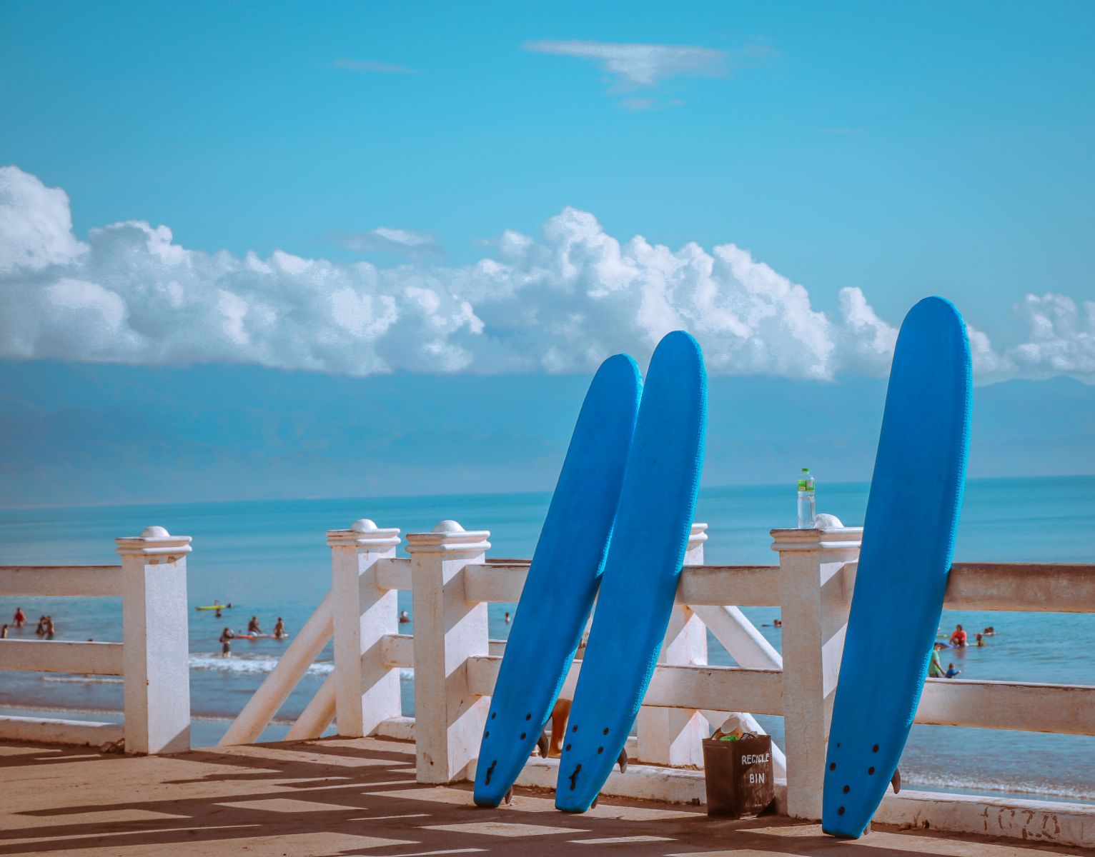 Find out about the weather in the Philippines in December for your winter sun escape; blue surfboards propped against a fence in Baler