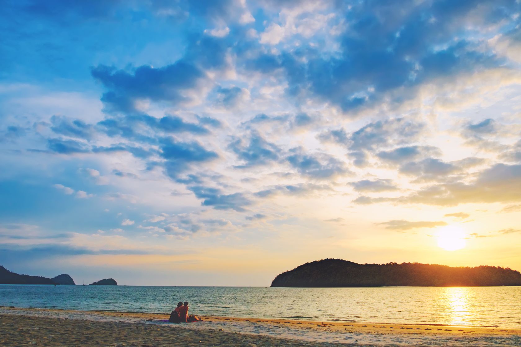 Couple on the beach at sunset, Pantai Tengah, Langkawi Island