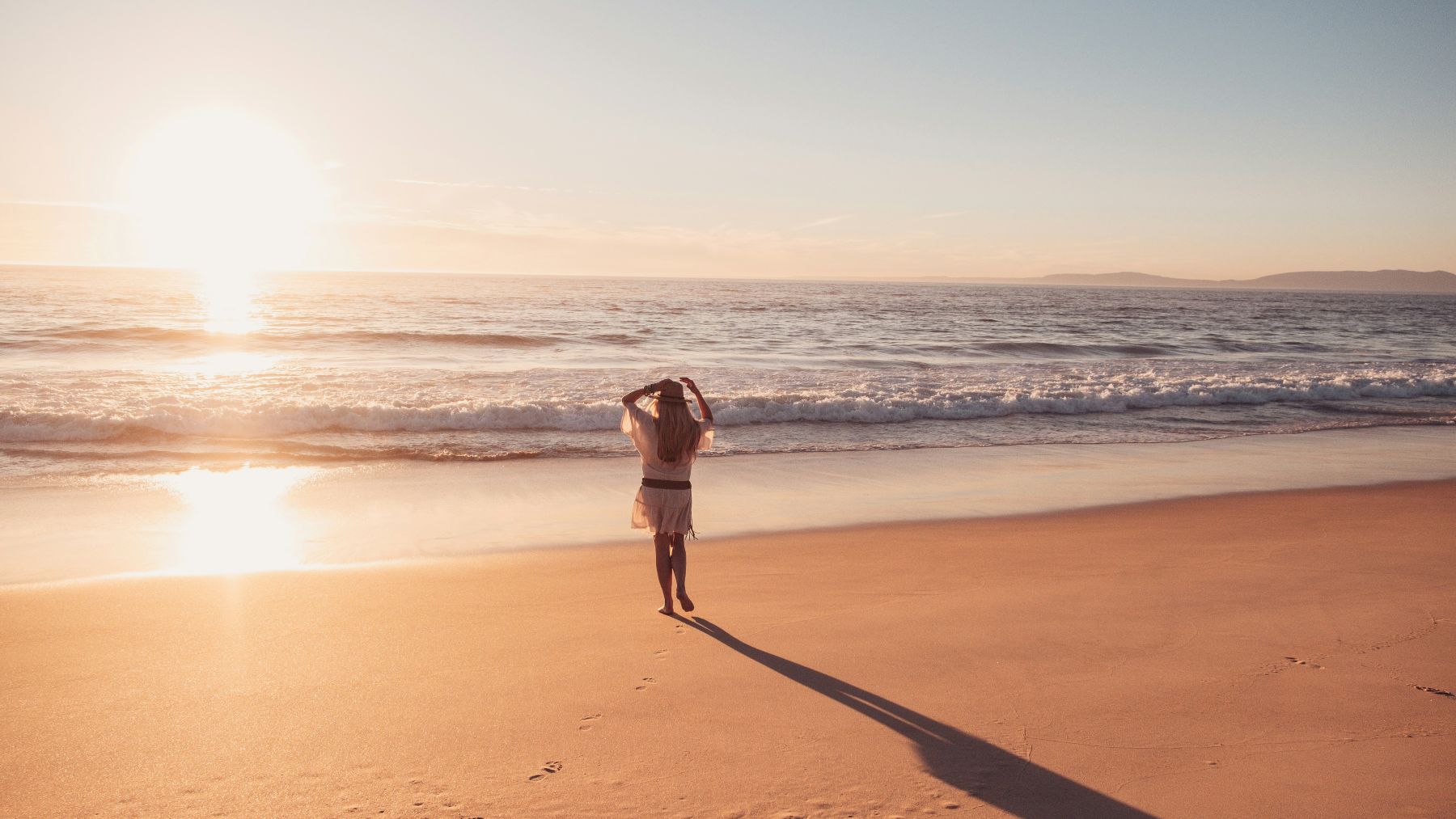 Person on a beach at sunset on vacation in Portugal