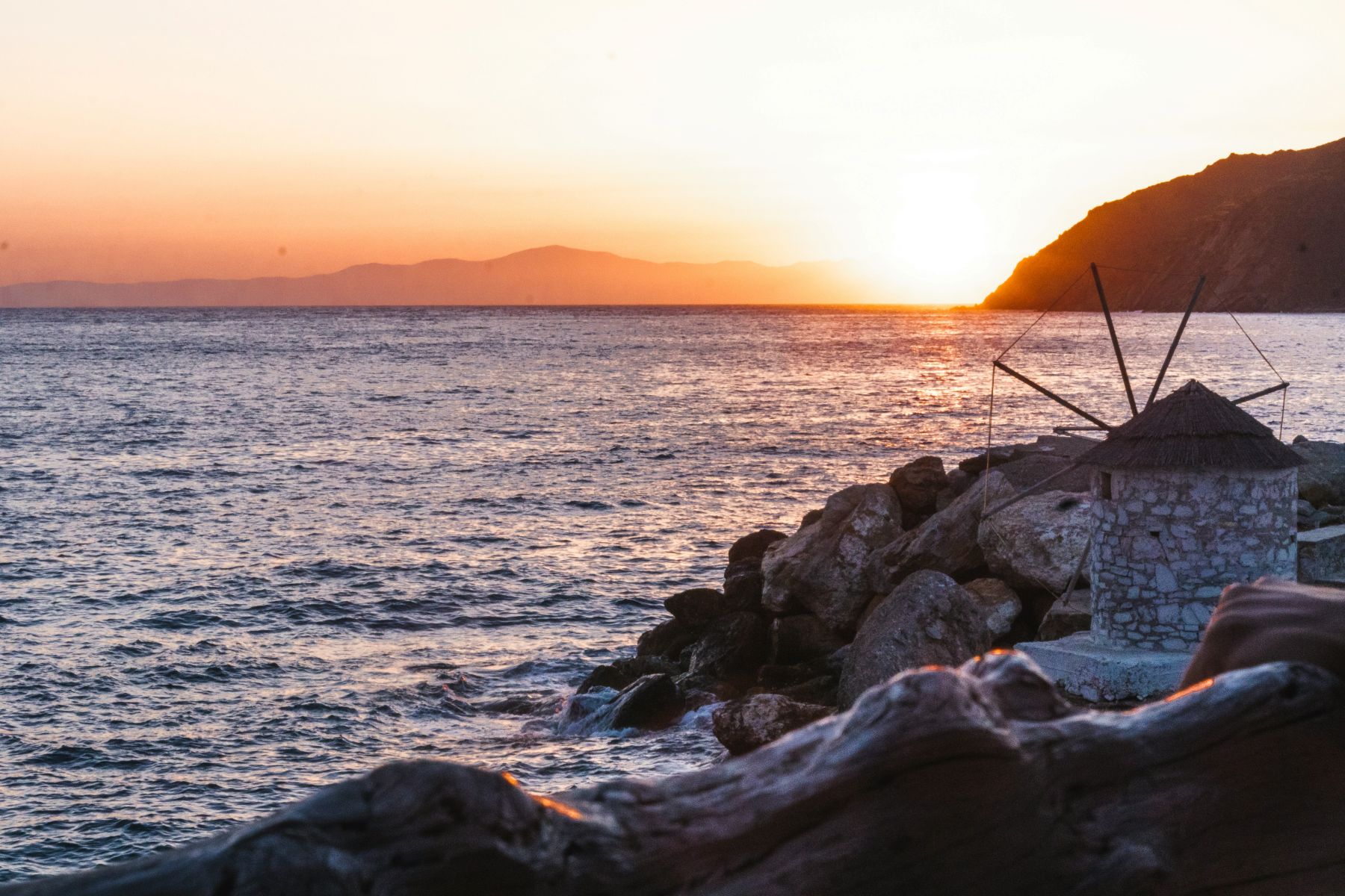 Sunset over calm waters off the island of Amorgos in Greece
