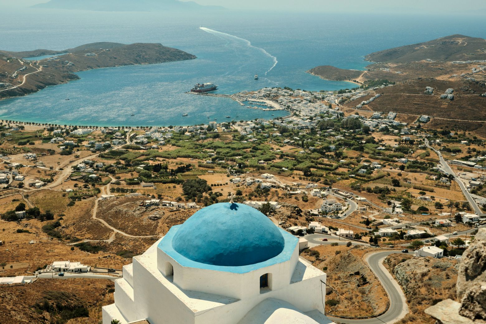 Hidden gems in Greece: the port of Serifos island and its surroundings with blue-domed church in the foreground