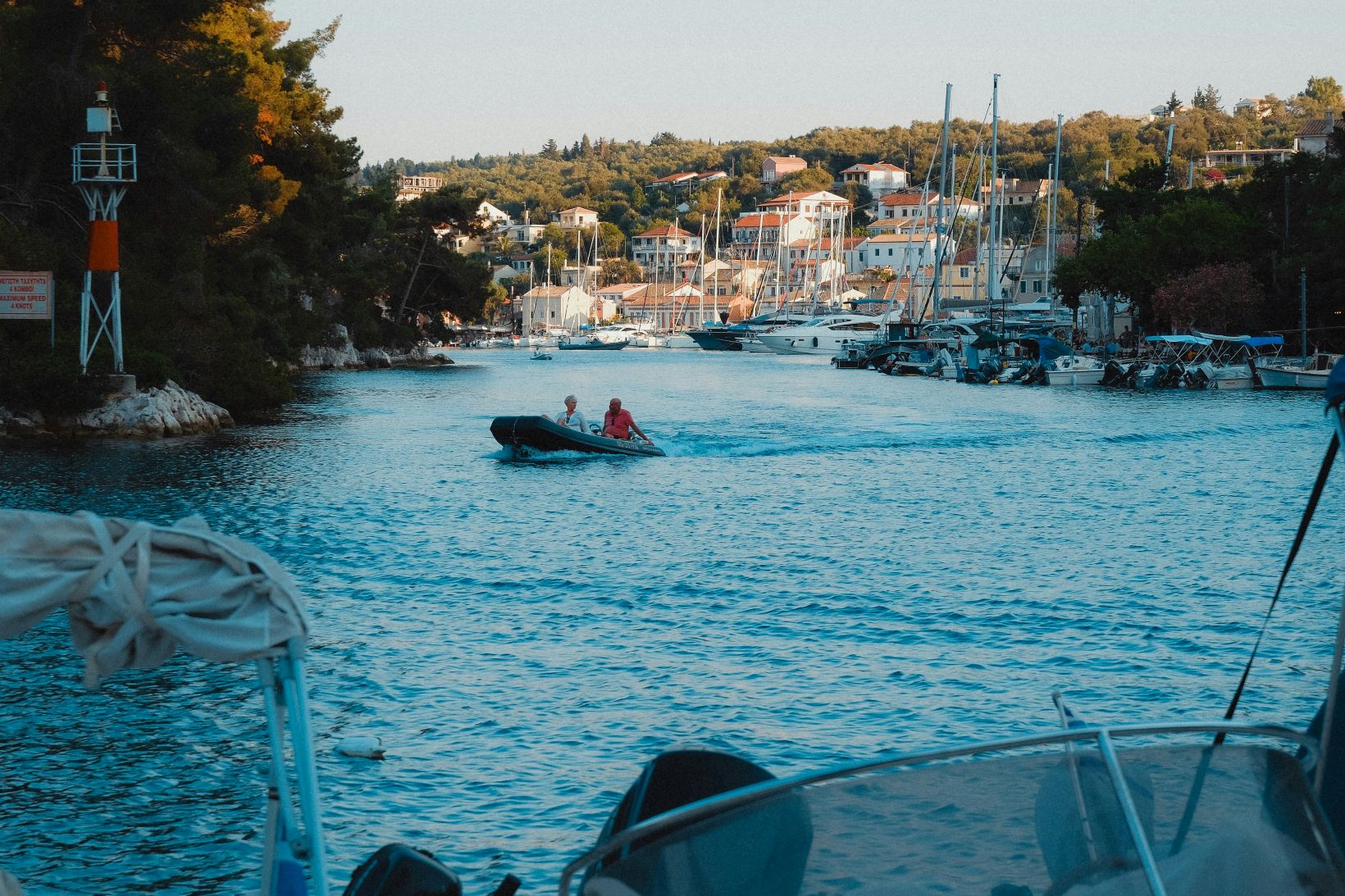 Couple boating near the harbor in Paxos, Greece