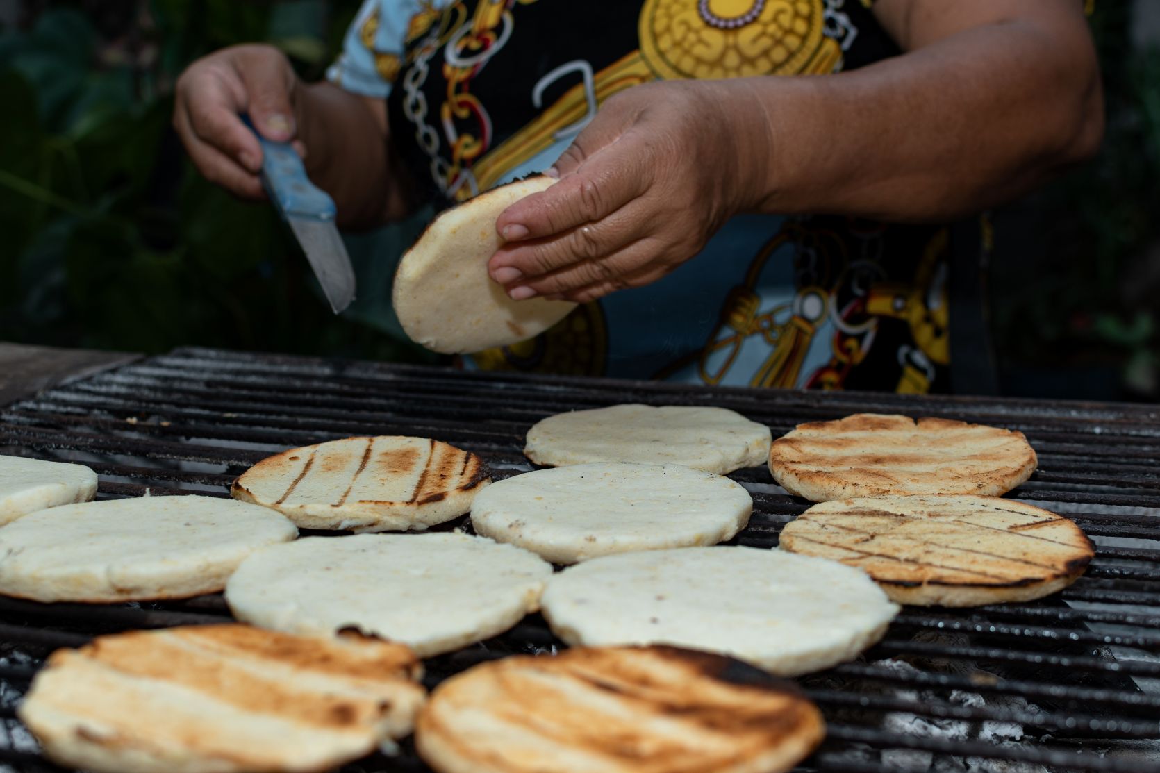 Hands preparing arepas, a Colombian speciality
